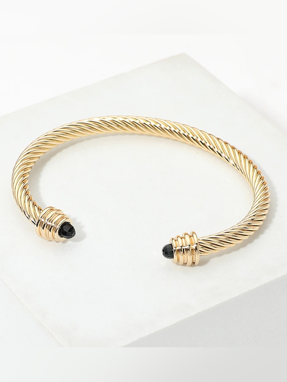 Gold Twisted Cable Cuff Bracelet with Black Stone Ends